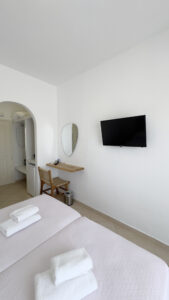 Double or Twin Room with wall-mounted TV, dressing table and flexible bedding configuration at Argo Rooms Antiparos.