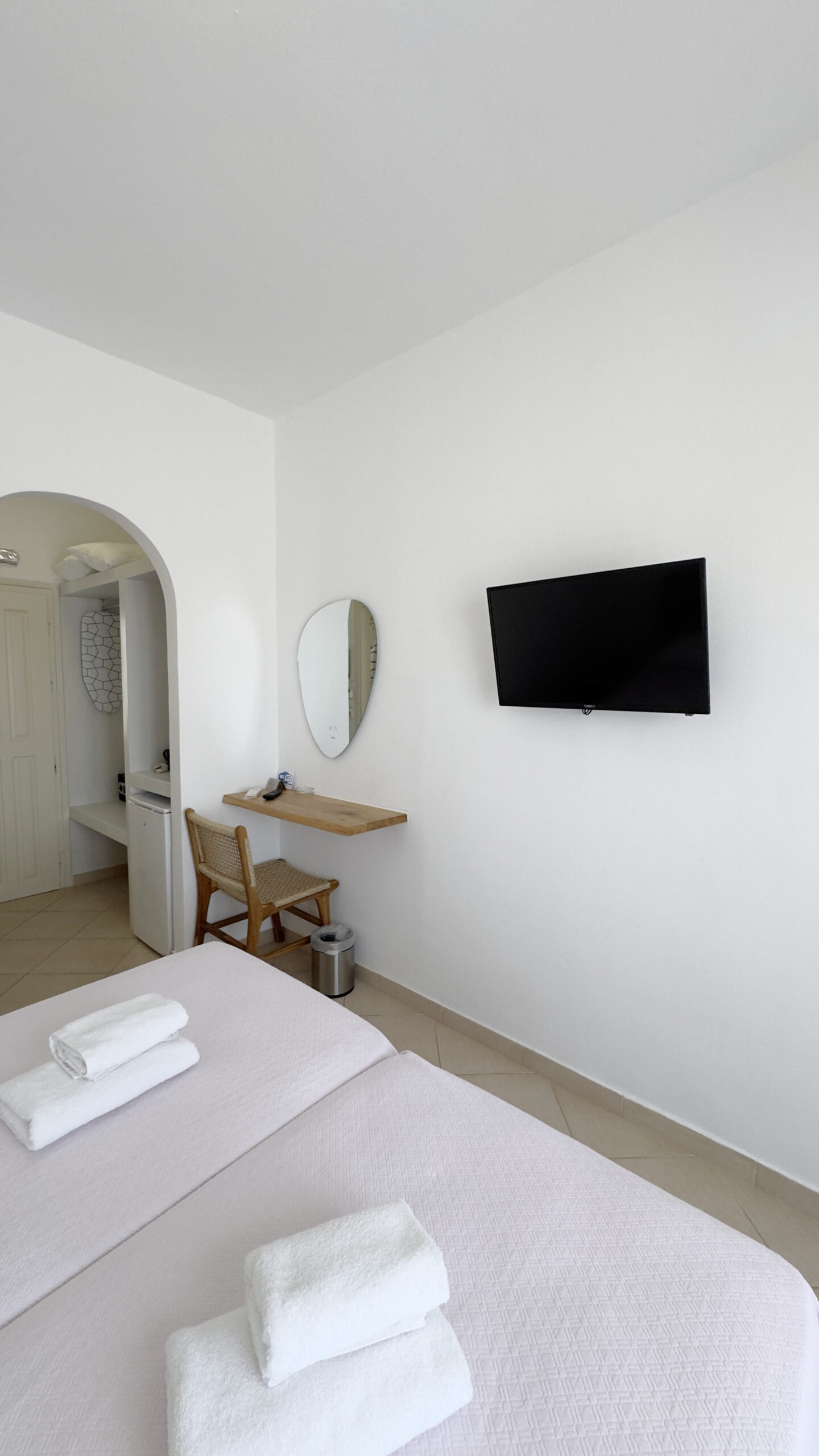 Double or Twin Room with wall-mounted TV, dressing table and flexible bedding configuration at Argo Rooms Antiparos.
