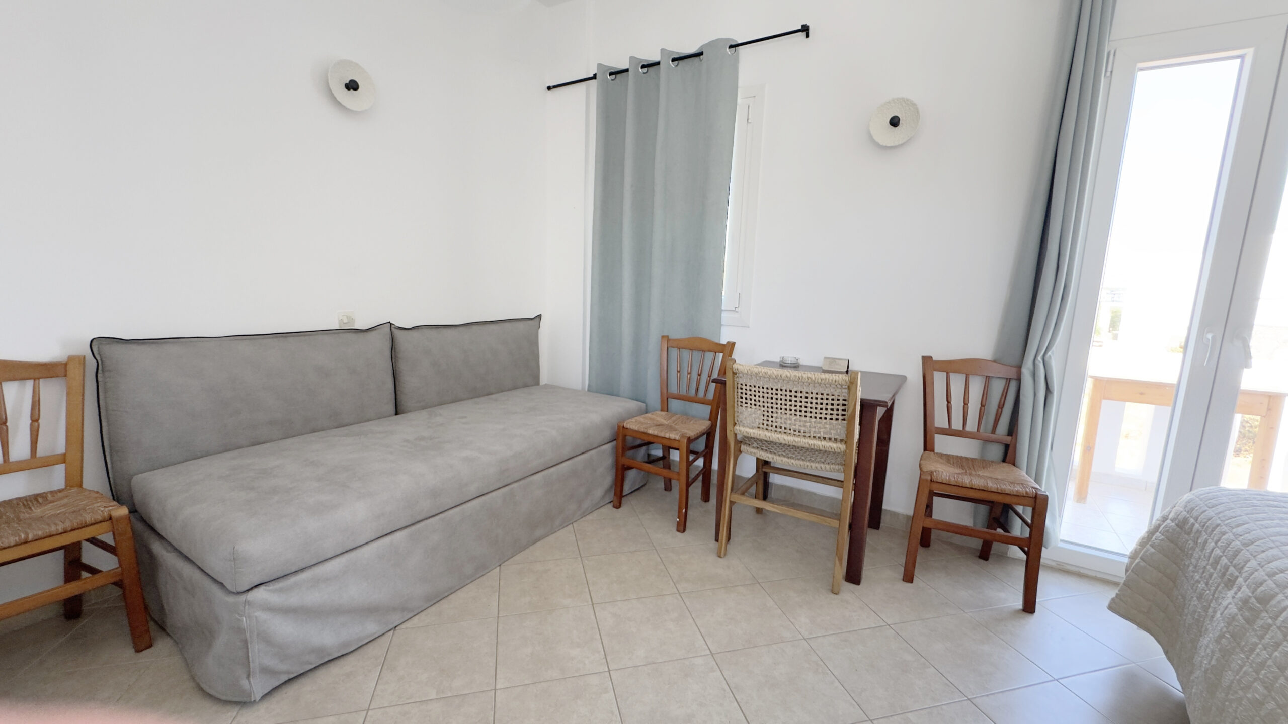 Double sofa bed with seating area and natural light in the Studio with Sofa Bed (4 Guests) at Argo Rooms Antiparos.