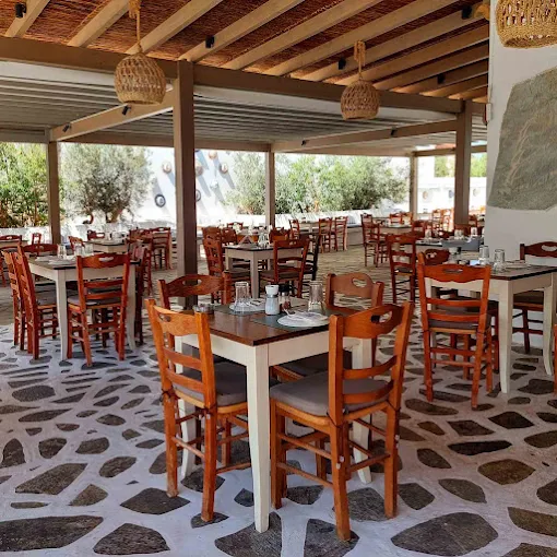 Traditional dining terrace with wooden tables at Argo Restaurant Antiparos
